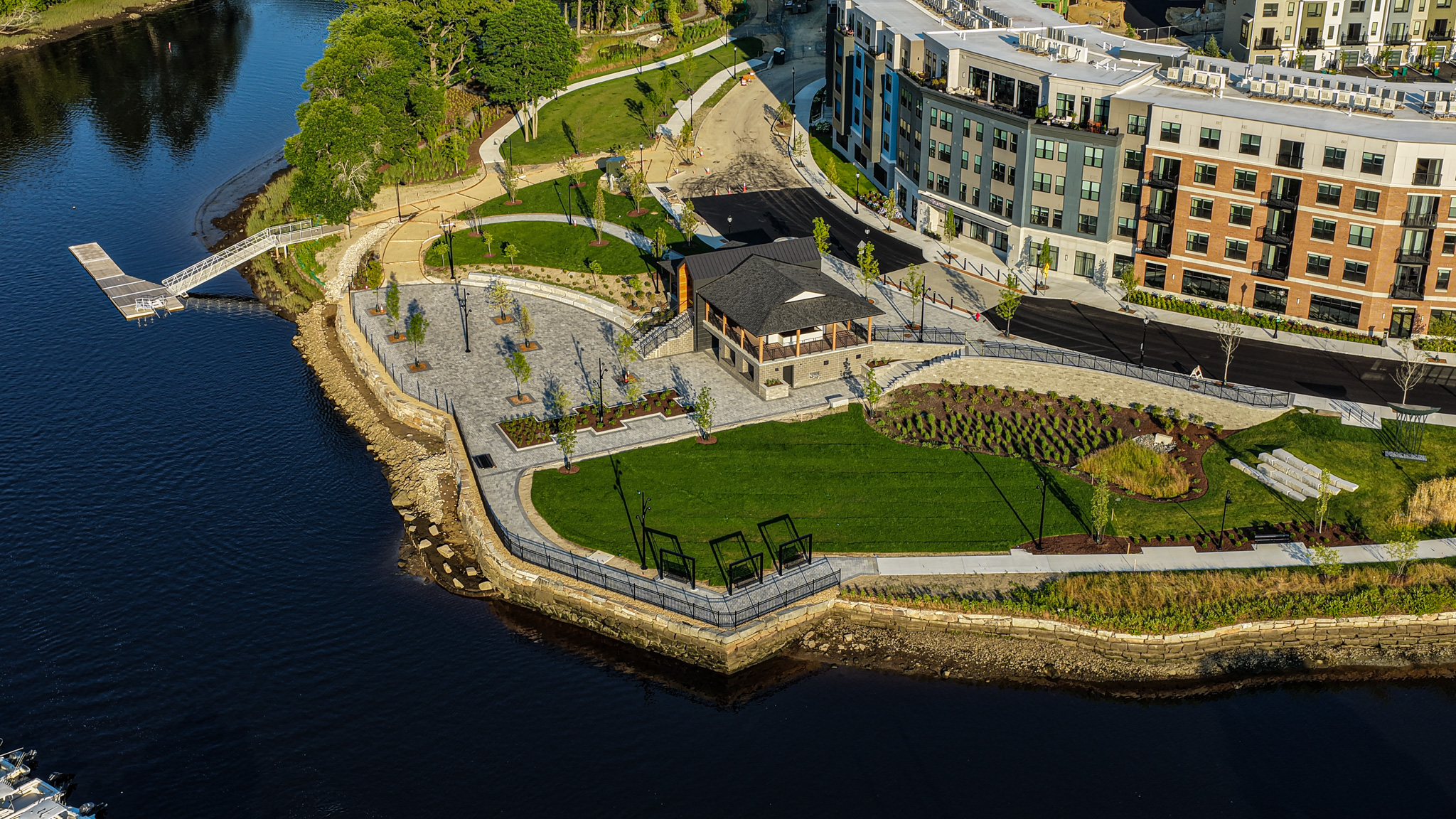 An aerial view of the Cochecho Waterfront Development project, showing the buildings, Nebi Park, the Pavilion, sports dock and river